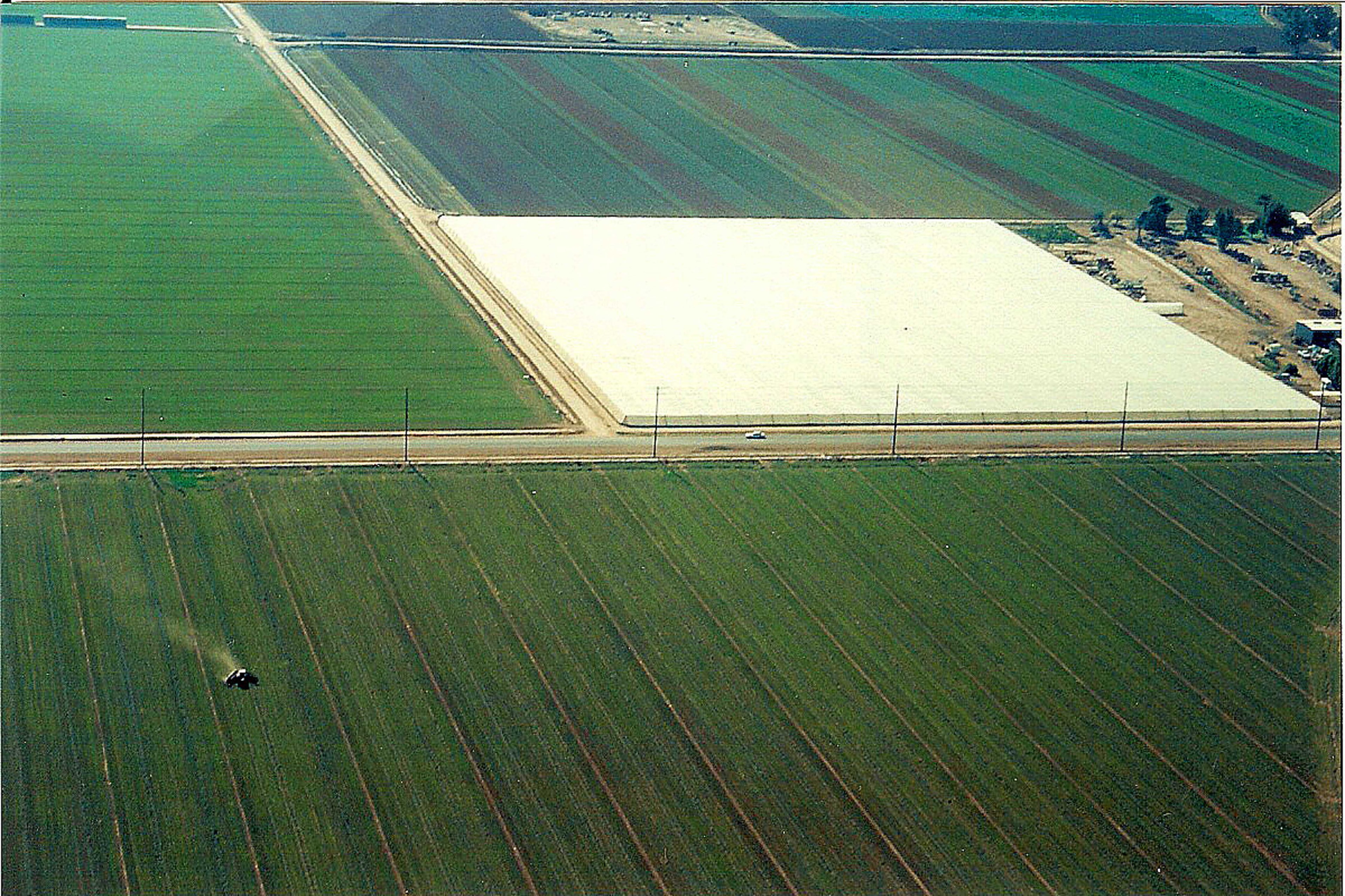 Aerial view of 16-acre insect screen structure surrounded by agricultural fields